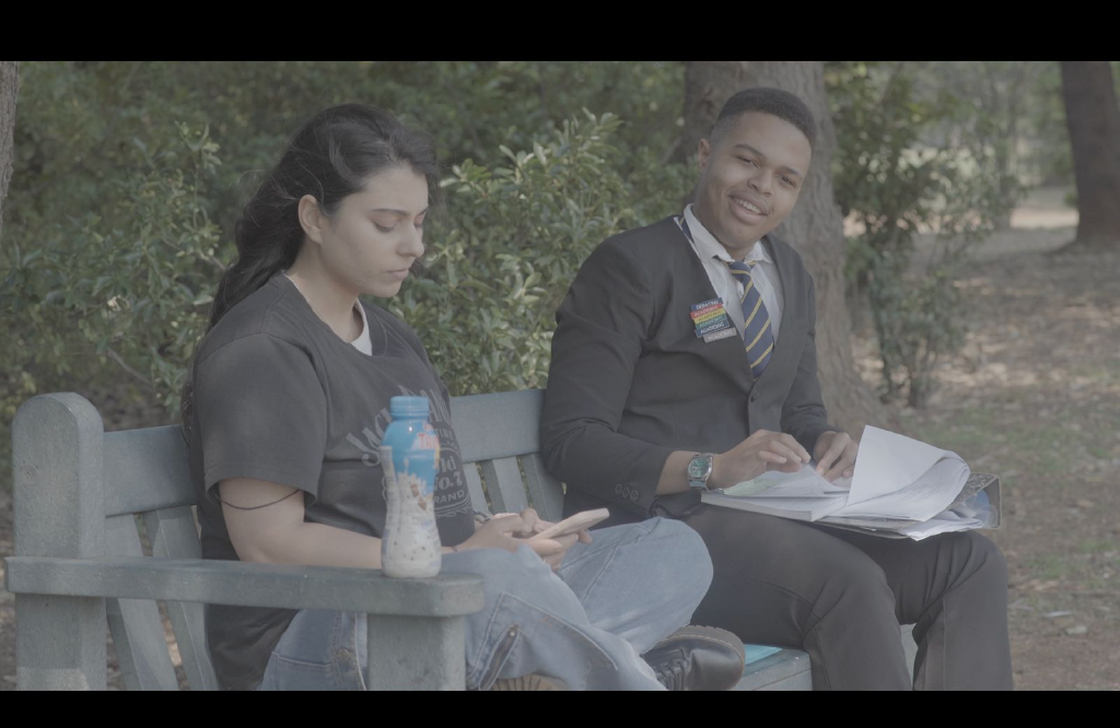 The Weight Of film scene featuring a bench conversation
